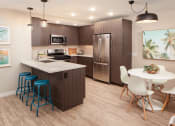 Thumbnail 6 of 16 - Kitchen with stainless steel appliances and dining area at Driftwood, San Diego, 92109