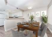 Thumbnail 2 of 52 - Dining Area with Table and Chairs and Kitchen in Background with Breakfast Bar and White Cabinetry at Westlake Canyon, California