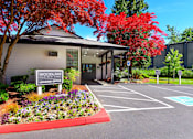 Thumbnail 9 of 46 - Leasing office and parking lot at Woodlake Apartments, Washington 98034