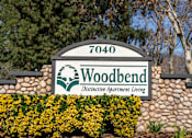 Thumbnail 58 of 81 - Property entrance sign with landscaping at Woodbend Apartments, Alta Loma, CA