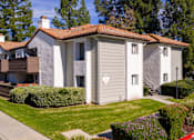 Thumbnail 23 of 81 - Residential building with balconies and green lawn at Woodbend Apartments, Alta Loma, California