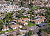 Thumbnail 55 of 81 - Aerial view of residential community with solar panels at Woodbend Apartments, Alta Loma, 91701