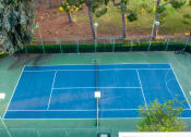 Thumbnail 13 of 40 - Two-Bedroom Apartments in Alta Loma, CA - Woodbend - Tennis Court with Fenced-in Area and Trees at Woodbend, Alta Loma, 91701