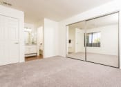 Thumbnail 19 of 40 - Bedroom with large mirror, closet and sink at Woodbend, Alta Loma, California