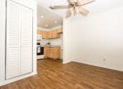 Thumbnail 24 of 40 - Dining area with ceiling fan and kitchen at Woodbend, Alta Loma, CA, 91701