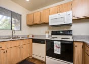 Thumbnail 26 of 40 - Kitchen with appliances and a window at Woodbend, California, 91701