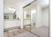 Thumbnail 28 of 40 - Bathroom sink and large mirror and closet at Woodbend, Alta Loma, CA, 91701