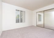 Thumbnail 32 of 40 - Bedroom with window and closet at Woodbend, Alta Loma