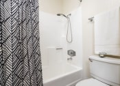 Thumbnail 34 of 40 - Bathroom with toilet and shower at Woodbend, Alta Loma, CA