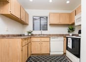 Thumbnail 37 of 40 - Kitchen with appliances and window at Woodbend, Alta Loma, CA, 91701