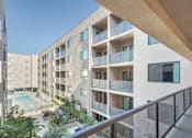 Thumbnail 24 of 26 - A modern apartment complex with a pool and balconies at Wilshire Valencia Apartment, Los Angeles, 90017