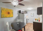 Thumbnail 4 of 20 - a living room with a dining room table and a kitchen