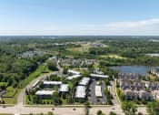 Thumbnail 20 of 20 - an aerial view of a city with houses and a lake