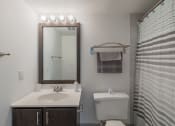 Thumbnail 7 of 20 - a bathroom with a toilet sink and a mirror