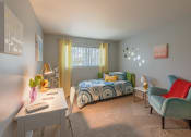 Thumbnail 5 of 20 - a bedroom with a bed and a desk and a chair