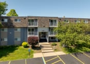 Thumbnail 10 of 20 - front view of an apartment building with sidewalks and grass