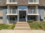 Thumbnail 9 of 20 - the front of an apartment building with stairs and a porch