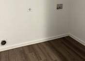 Thumbnail 11 of 16 - A white wall with a picture frame and a white shelf.