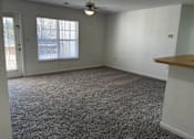 Thumbnail 9 of 16 - A room with a carpeted floor and a ceiling fan.