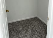 Thumbnail 13 of 16 - A white door is open to a small room with a metal rack on the wall.