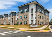 Thumbnail 1 of 10 - A large apartment complex with the name "Crestmoor" on the front.