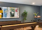 Thumbnail 8 of 10 - A room with a pool table and a painting on the wall.