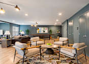 Thumbnail 4 of 10 - A living room with grey walls and a grey sofa.