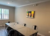 Thumbnail 14 of 15 - a meeting room with a large table and chairs