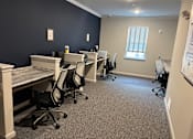 Thumbnail 6 of 15 - an office with desks and chairs