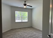 Thumbnail 2 of 15 - a bedroom with a ceiling fan and a window