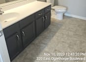 Thumbnail 14 of 14 - A bathroom with a toilet, sink, and bathtub.