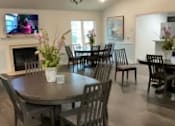 Thumbnail 3 of 7 - A dining room with a table and chairs.