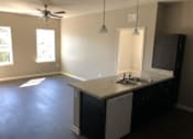 Thumbnail 2 of 8 - A kitchen with a white dishwasher and a sink.