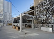 Thumbnail 5 of 13 - A large mural of horses is on the side of a building.