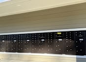 Thumbnail 9 of 9 - A row of black electrical switchboards are mounted on a wall.