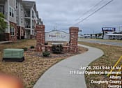 Thumbnail 1 of 14 - A sign for Flint Ridge Apartments is displayed in front of a brick wall.