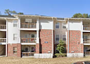Thumbnail 2 of 16 - Apartment building with balconies and doors visible.