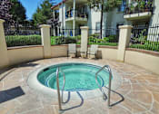 Thumbnail 4 of 18 - a small hot tub in a pool in front of an apartment building