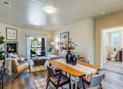 Thumbnail 50 of 53 - A living room with a fireplace and a dining table.