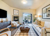Thumbnail 42 of 53 - A living room with a fireplace and a couch.