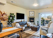 Thumbnail 45 of 53 - A living room with a fireplace and a flat screen TV.