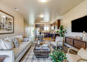 Thumbnail 48 of 53 - A living room with a white couch and a coffee table.