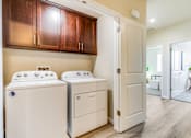Thumbnail 35 of 53 - A laundry room with a washer and dryer.