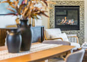 Thumbnail 30 of 53 - A dining room with a fireplace and a painting on the wall.