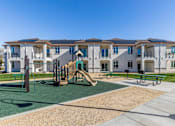 Thumbnail 13 of 53 - A playground area in front of apartment buildings.