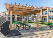 Thumbnail 5 of 53 - A wooden pergola is over a picnic table.