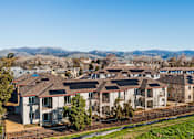 Thumbnail 9 of 53 - A row of houses with a mountain range in the background.