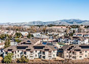 Thumbnail 3 of 53 - A suburban neighborhood with houses and mountains in the background.