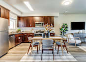 Thumbnail 38 of 53 - A modern kitchen with a dining table set for four.