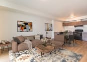 Thumbnail 56 of 57 - a living room with two couches and a coffee table in front of a kitchen with a at Jefferson Yards, Tacoma, WA 98402
